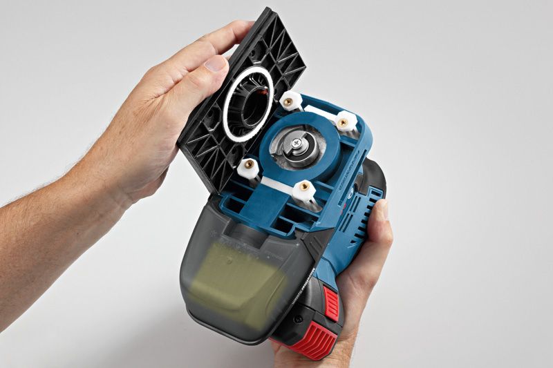 Person holding a cordless orbital sander with the base plate removed.