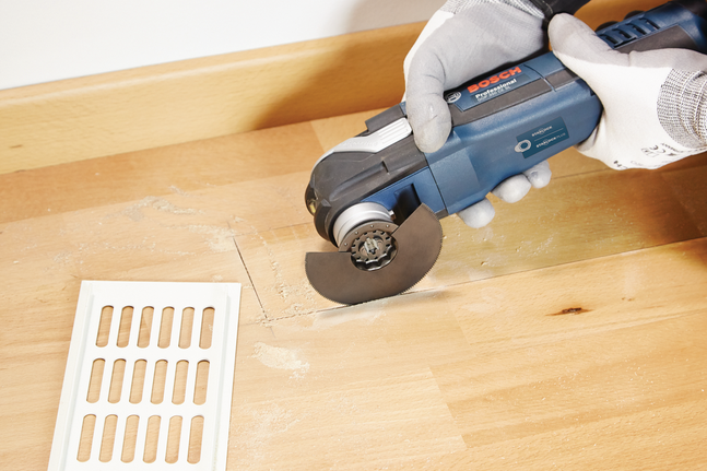HCS segment saw blade ACZ 85 EC Wood Person wearing safety equipment uses a power tool to cut a wooden floor.