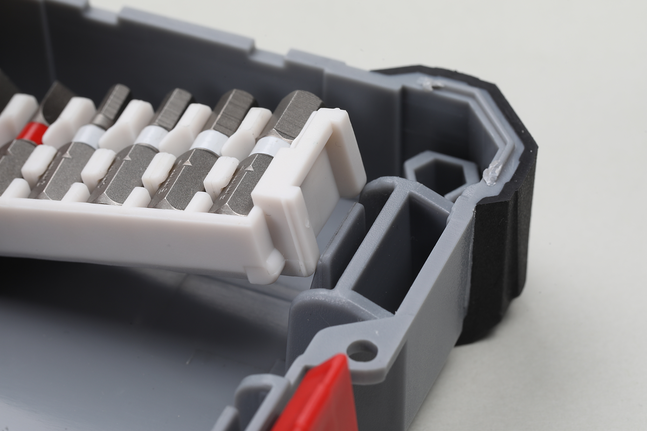 Assorted screwdriver bits arranged in a gray plastic case.