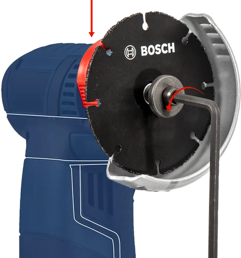 Hex key tightening a circular saw blade on a power tool.