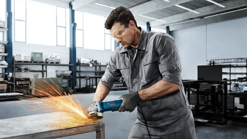 Man grinding metal table.