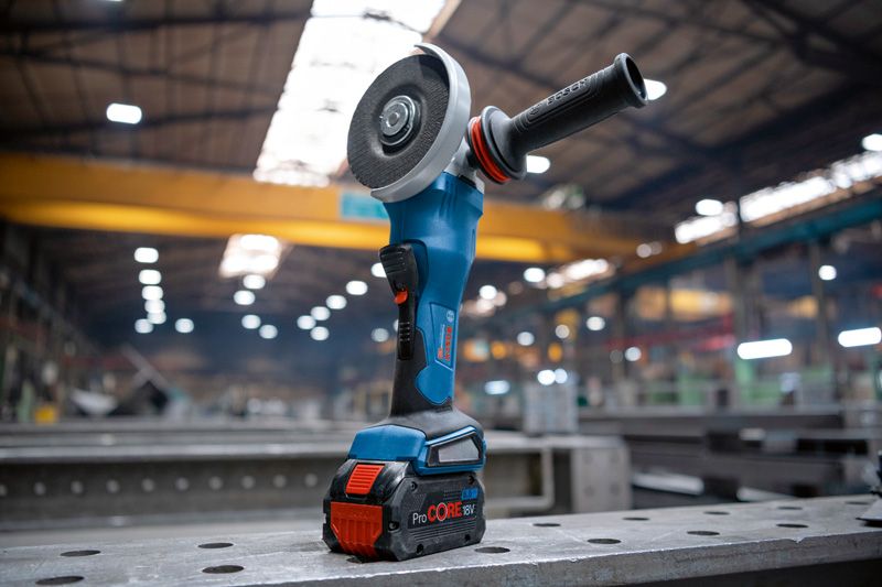Bosch GWS 18V-15 P cordless angle grinder on workbench.