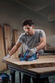 Bosch GHO 185-LI cordless planer smoothing wood.