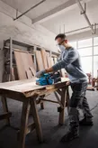 Bosch GBS 750 belt sander smoothing wooden plank.