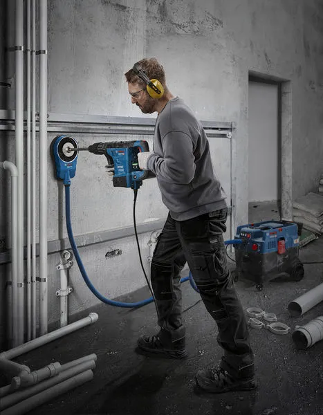 Bosch GBH 6-42 rotary hammer drilling into concrete wall.