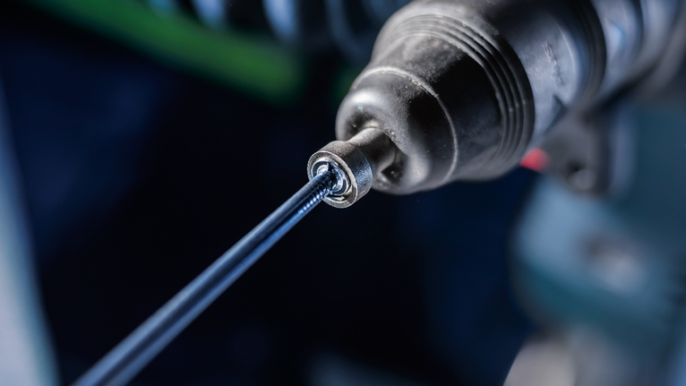 PRO SDS plus Rod Driver, 58 mm Close-up of a power drill driving a screw into a surface.