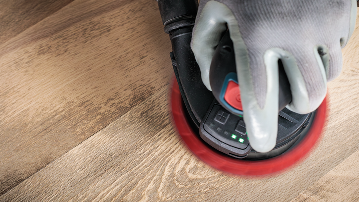 Object #200471070: 7390919_app_web_12 Worker wearing safety equipment sanding a wooden surface with a handheld power sander.