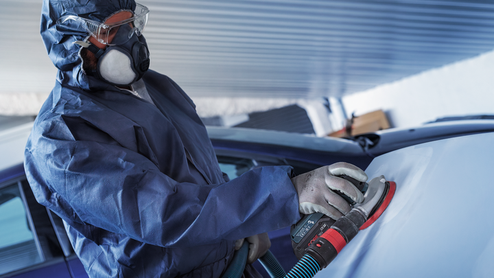 Object #200471076: 7390919_app_web_7 Worker wearing safety equipment sands a car surface with a power sander.
