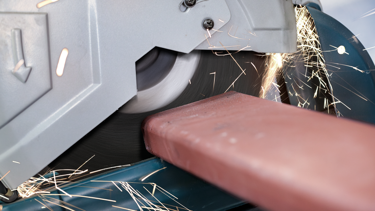 PRO Metal Cutting Disc, 305 x 3 x 25.4 mm Cut-off saw slicing through a metal beam, creating sparks.