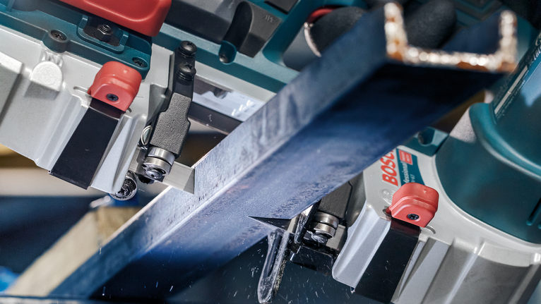 PRO CB281418 Band Saw Blade, 733 mm, 2 pcs Metal beam being precisely cut by a power saw in an industrial setting.