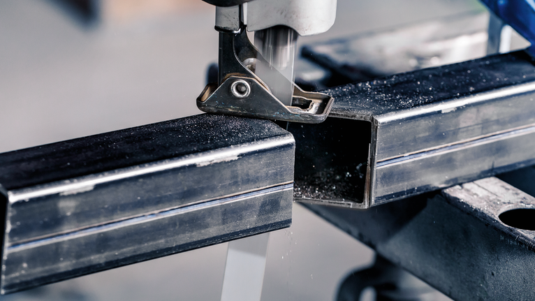 PRO Thick Metal precise S1137HBF Blade, 1.1 x 25 x 225 mm, 5 pcs Jigsaw cutting through a metal square tube on a workbench.