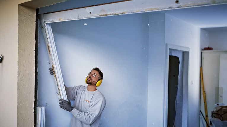 PRO Window Demolition S611DF Blade, 1.25 x 19 x 150 mm, 2 pcs Person wearing safety equipment removes a door frame inside a building.