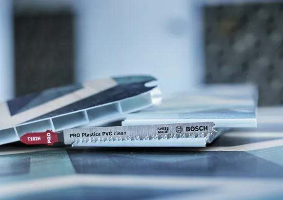 Jigsaw blade positioned near PVC panels for clean plastic cutting.