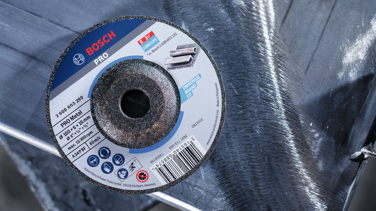 Cutting disc resting on a shiny metal surface.