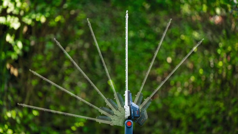 GHE 18V-50 TP Cordless telescopic hedgecutter showing adjustable cutting angles outdoors.