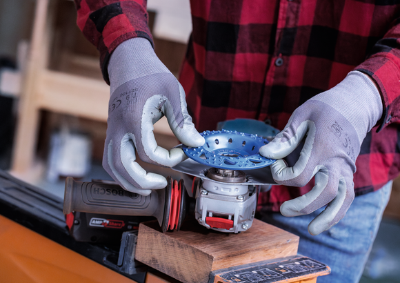 Object #200557593: 7425288_APP_WIDE_4 Person wearing safety equipment attaches a cutting disc to a power tool.