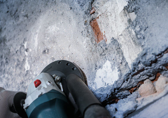 Object #200573496: 7743905_app_close_2 Bosch concrete grinding cup removing mortar from wall.