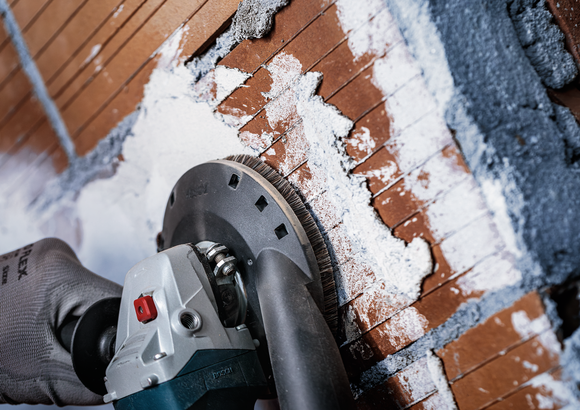 Object #200573498: 7743905_app_close_4 Bosch diamond grinding cup removing plaster from brick wall.