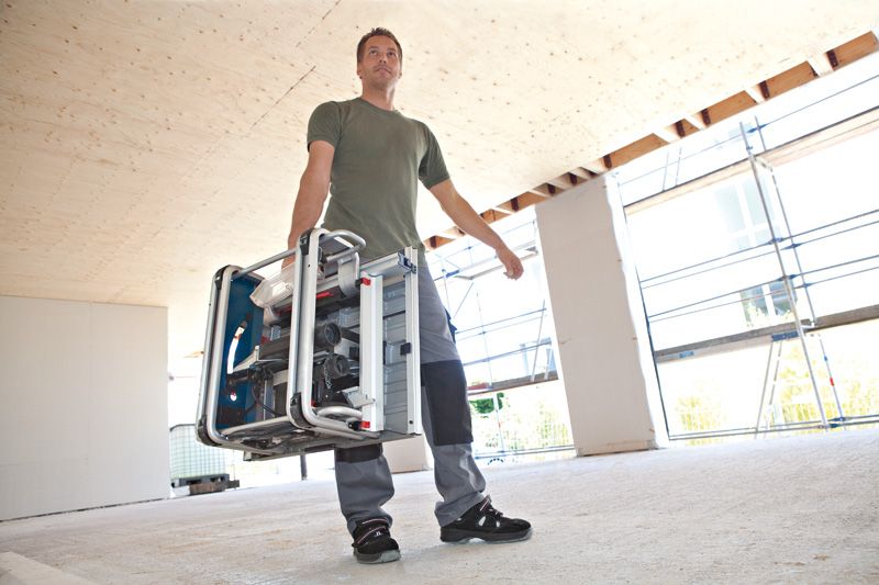 Man carrying table saw.